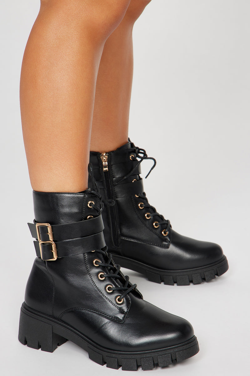 Black combat boots shop with gold buckles