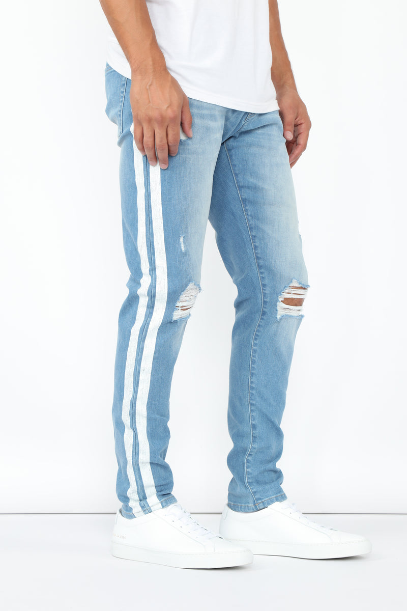 Blue jeans with white stripe down the side 2025