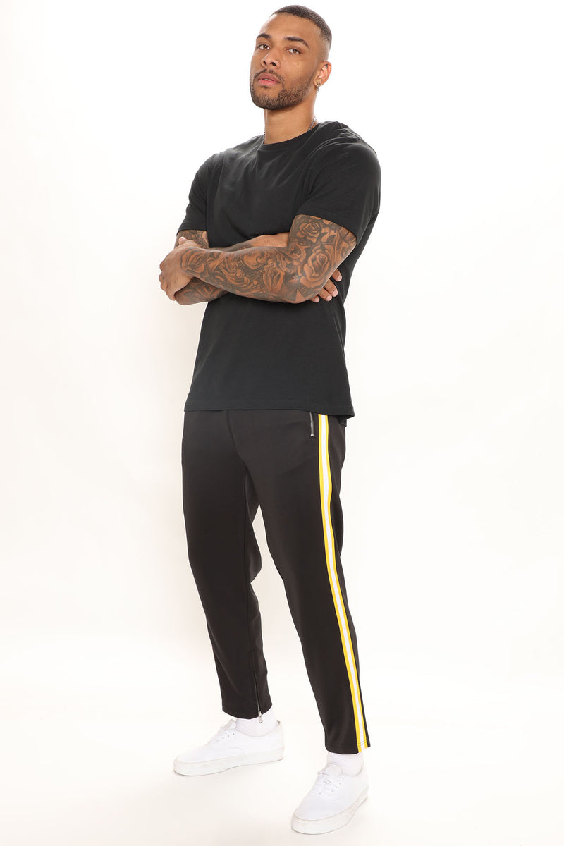 Black sweatpants with deals yellow stripe